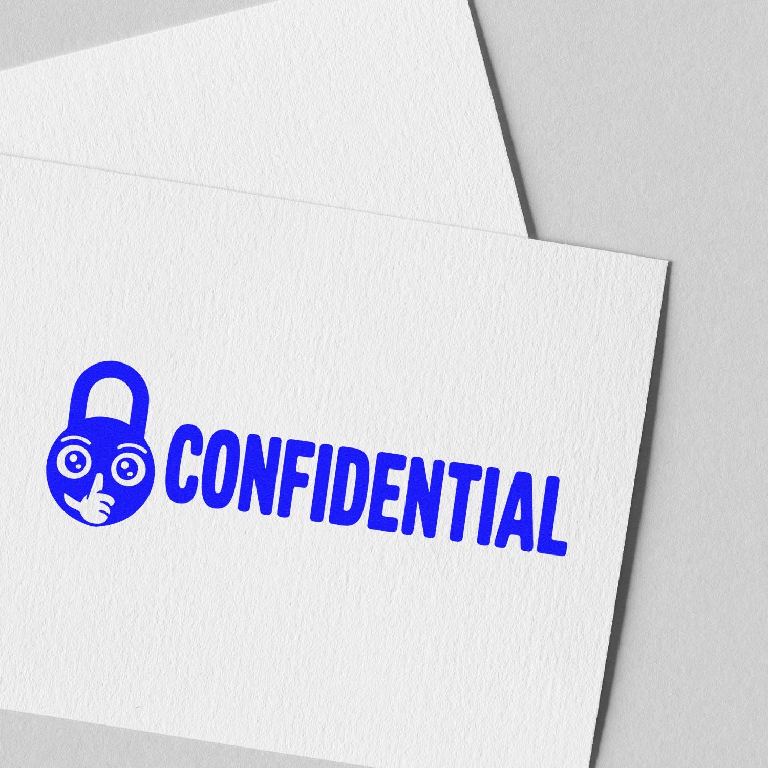 Confidential rubber stamp imprint on white paper envelopes for secure document handling.