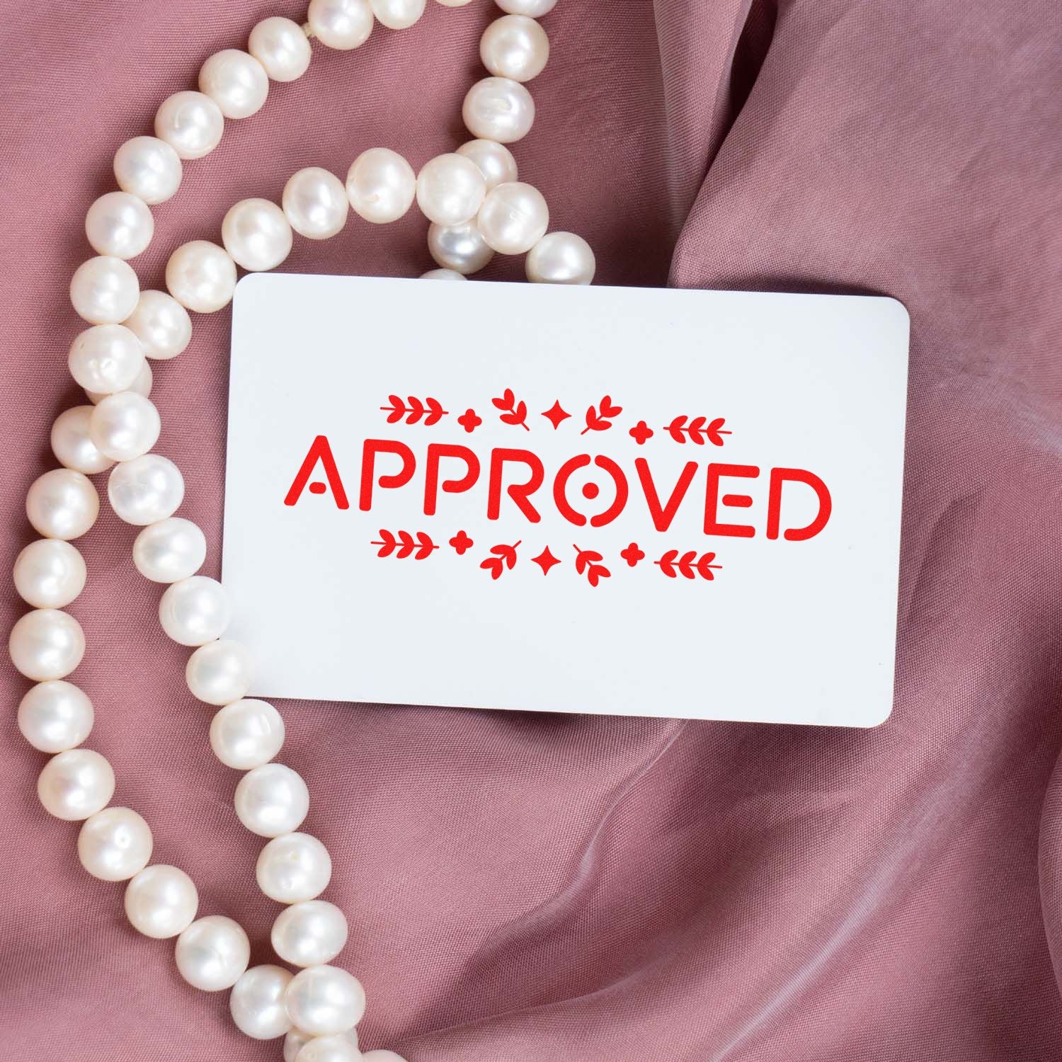 Red APPROVED rubber stamp concept on a white card, ideal for business approval, office supplies, and custom stamps.