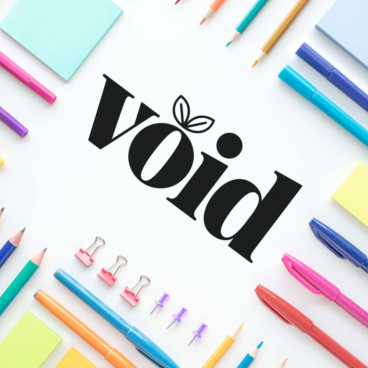 Void rubber stamp design surrounded by colorful stationery, ideal for marking canceled documents or packaging.