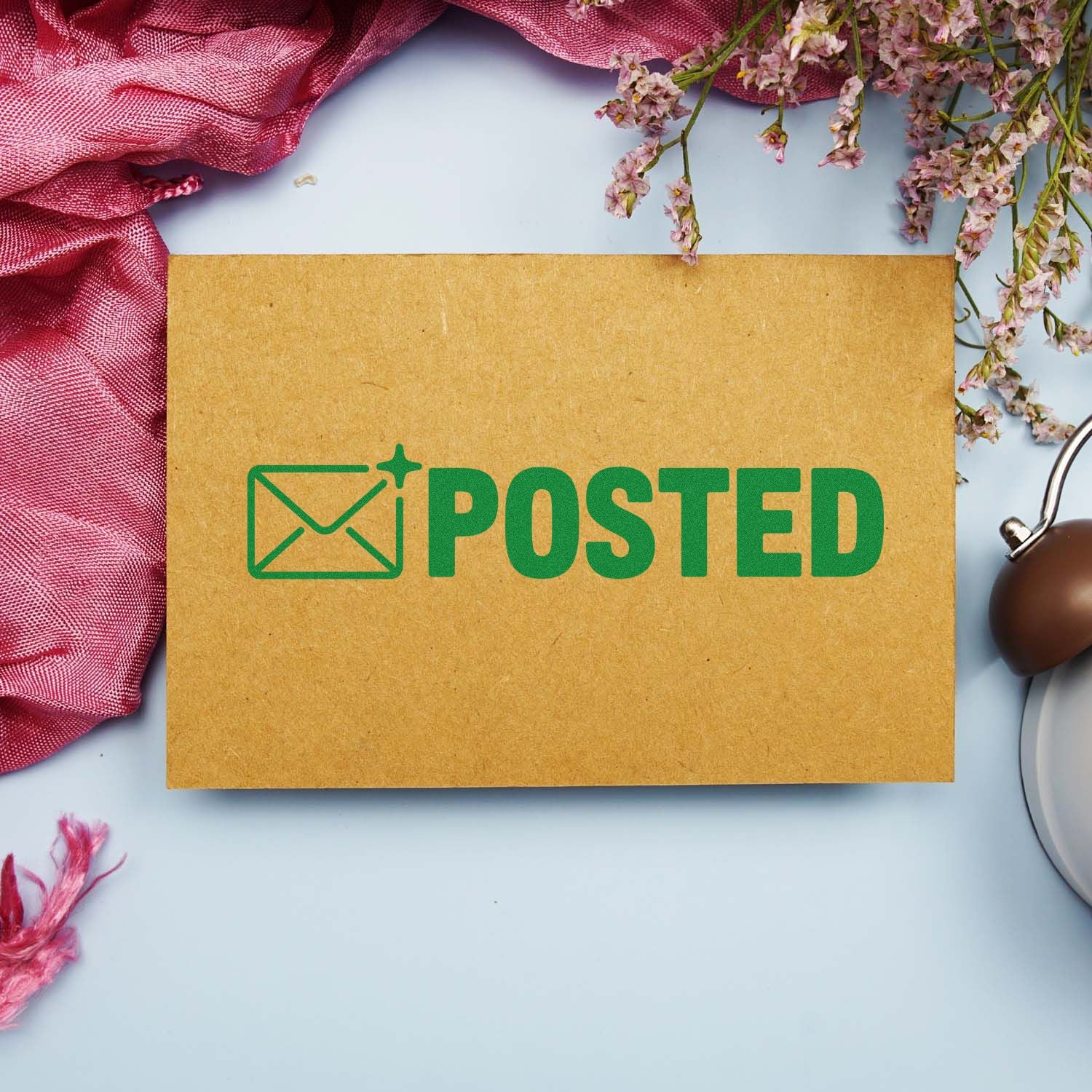 Posted rubber stamp impression on kraft envelope for mail and stationery branding.