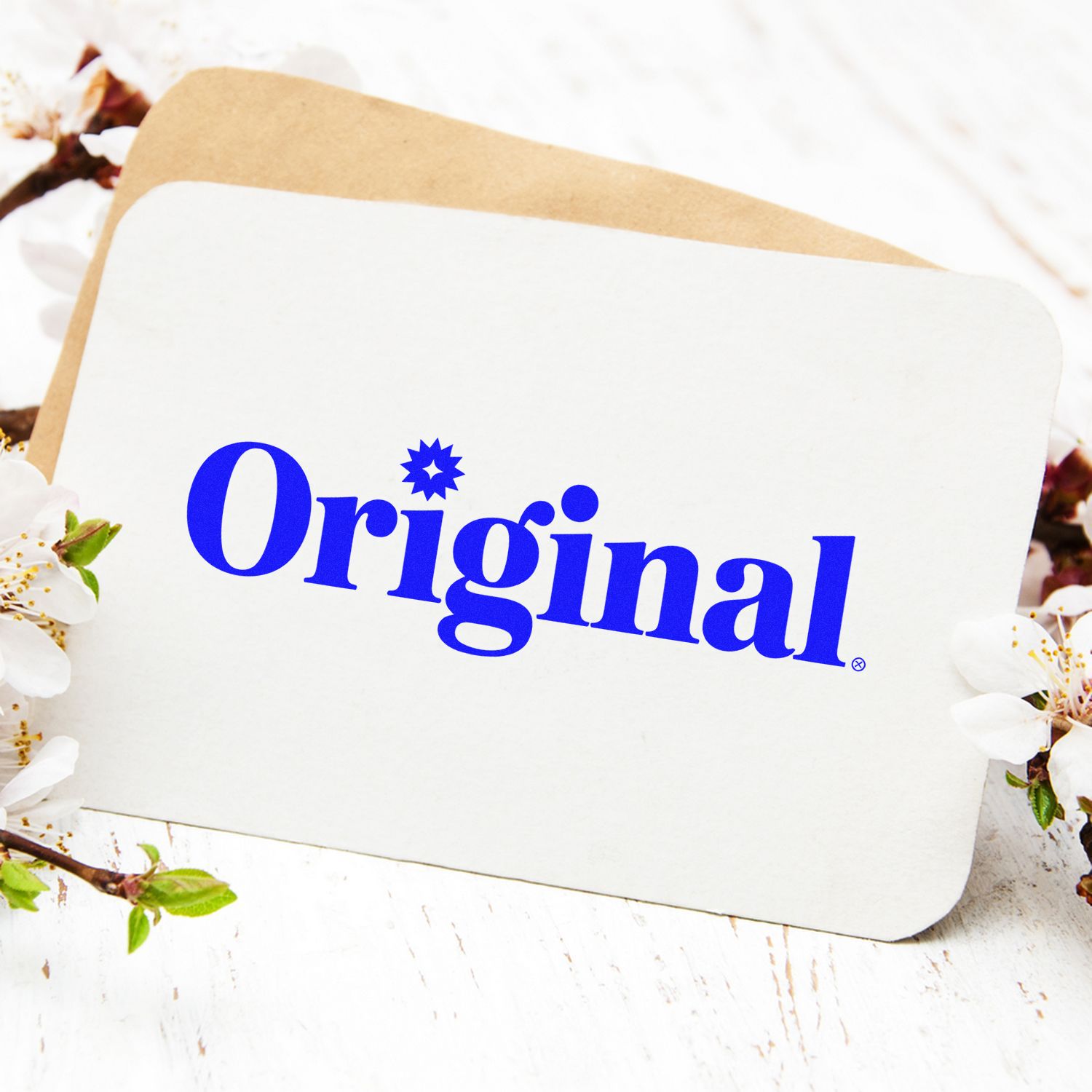 Original rubber stamp design in bold blue lettering on a blank card, ideal for custom stationery and branding.