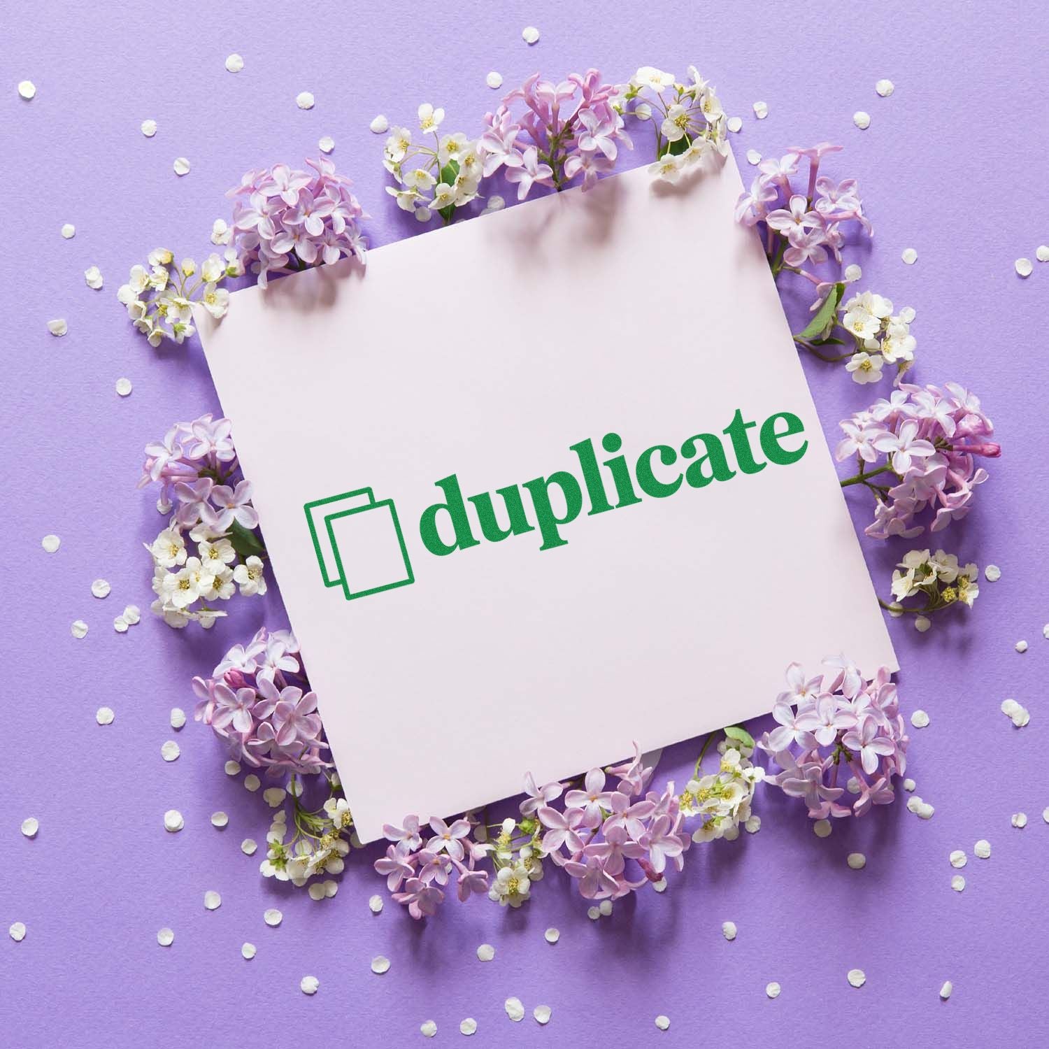 Green duplicate rubber stamp design on a floral purple background, ideal for marking copies in office paperwork.