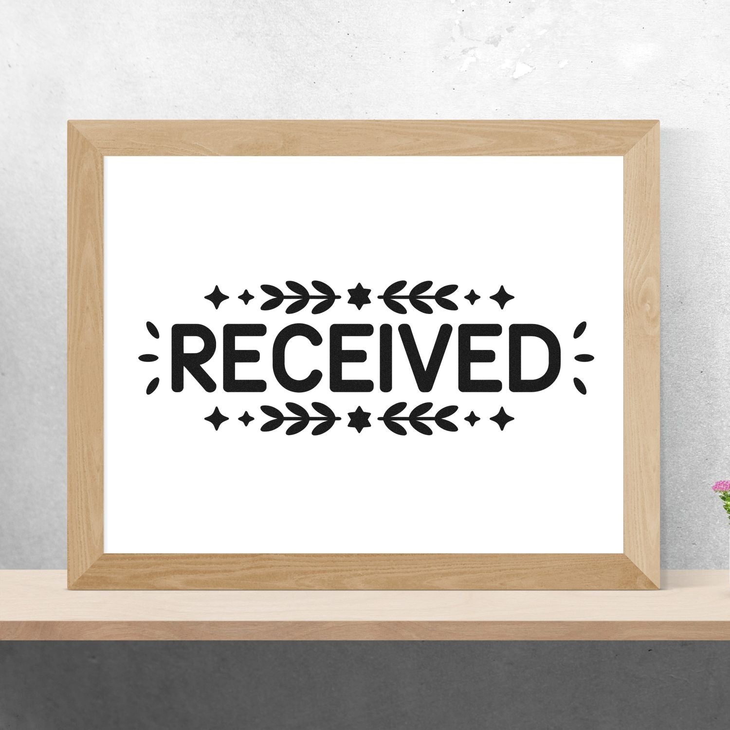 Decorative RECEIVED rubber stamp design for office mail, packaging, and document approval marking.