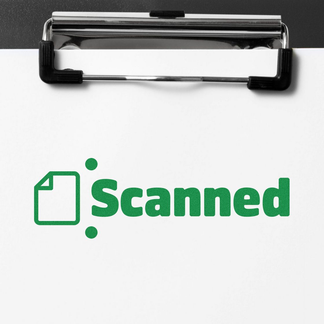 Green scanned rubber stamp on a clipboard, indicating a document has been digitized for office filing.