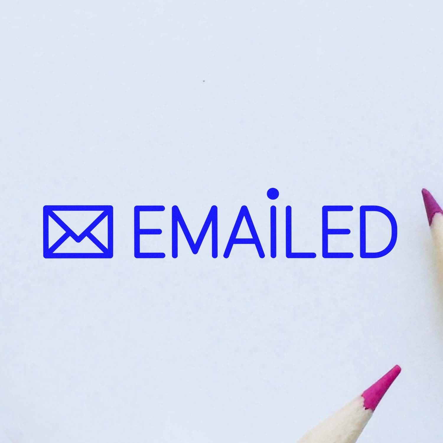 Blue emailed rubber stamp with envelope icon on paper, ideal for marking completed email correspondence.