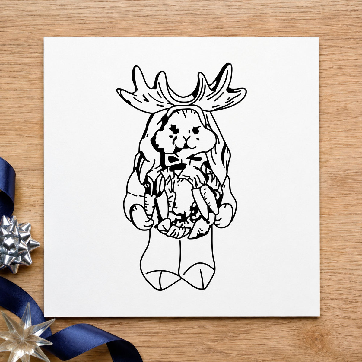 Bunny in Reindeer Costume Rubber Stamp impression in black ink on white paper in a styled craft setting.