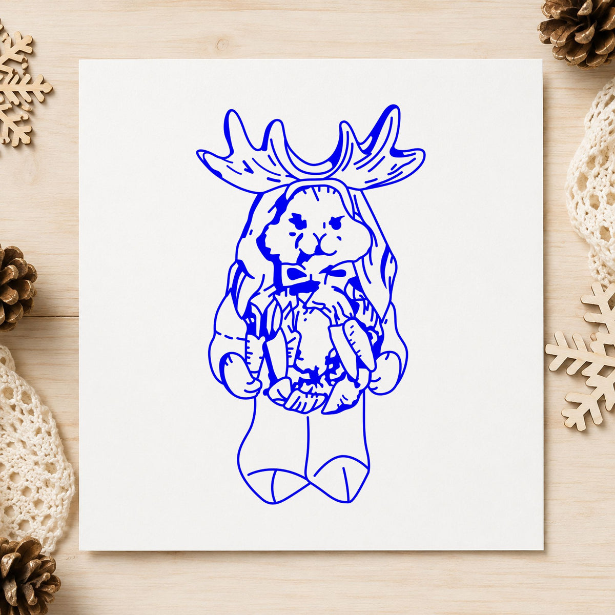 Blue holiday animal craft stamp impression featuring the bunny in reindeer costume design on white paper.