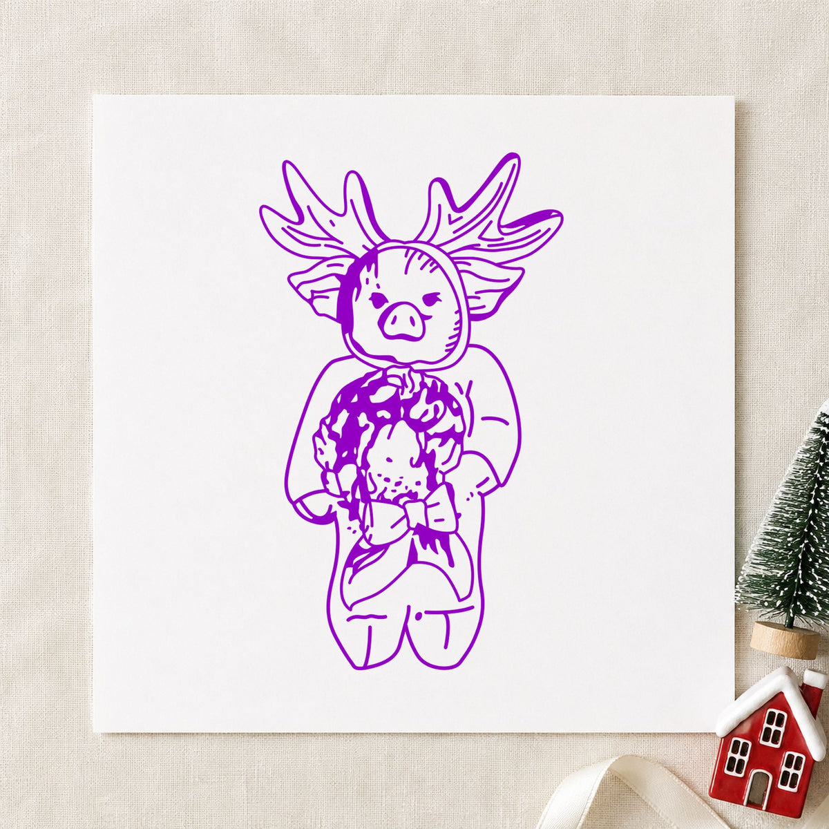 Pig in Reindeer Costume Rubber Stamp impression in purple ink on white paper in a styled craft setting.