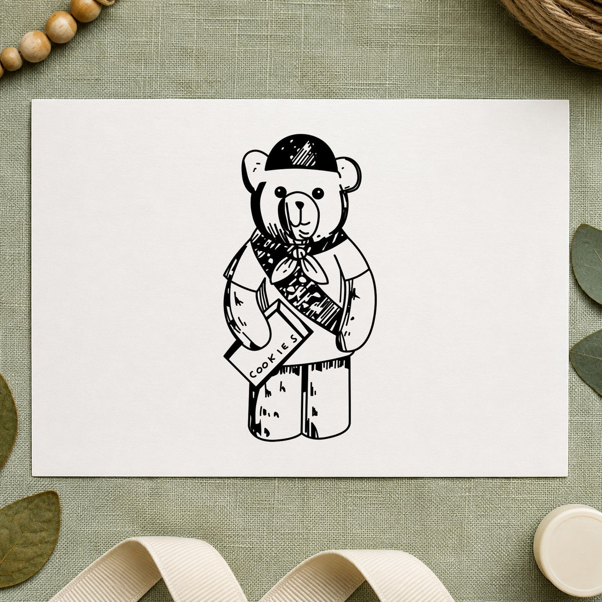 Scout Bear Rubber Stamp impression in black ink on white paper in a styled craft setting.