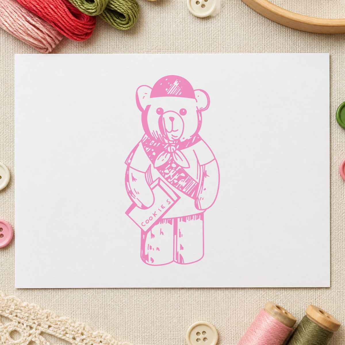 Scout Bear Rubber Stamp impression in pink ink on white paper in a styled craft setting.