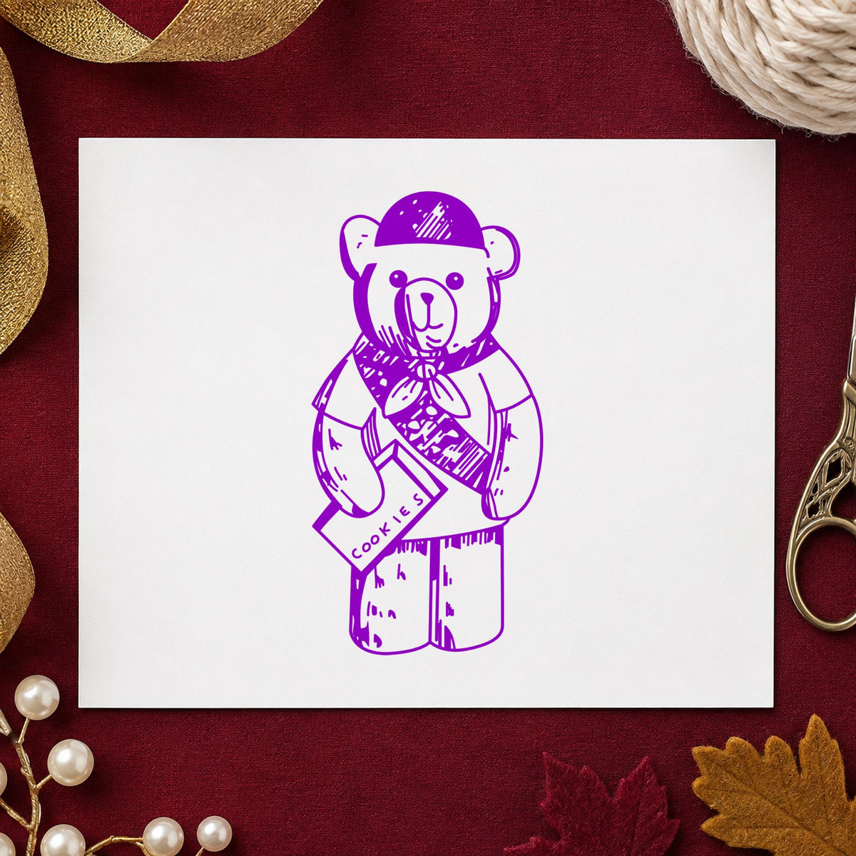 Scout Bear Rubber Stamp impression in purple ink on white paper in a styled craft setting.