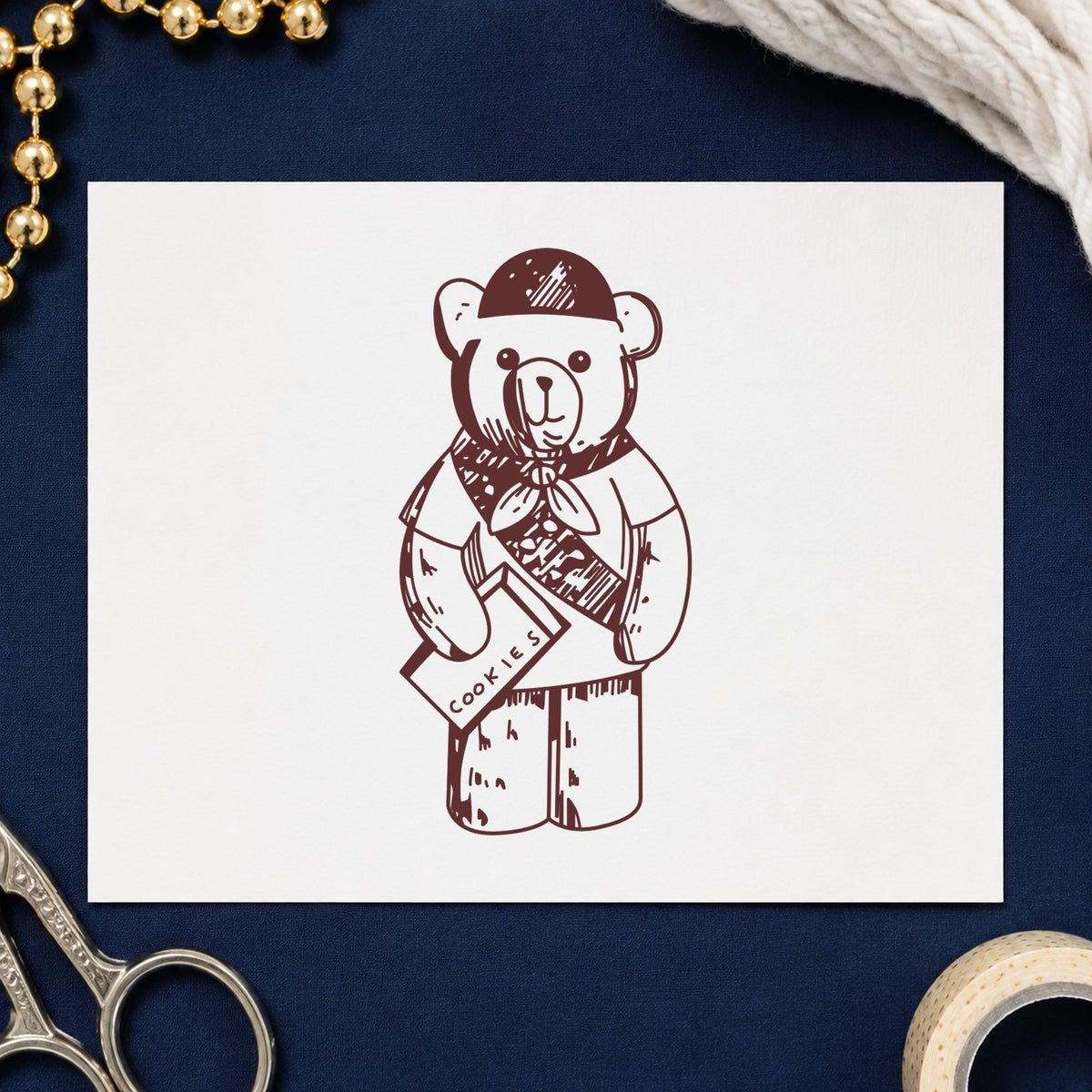 Scout Bear Rubber Stamp impression in brown ink on white paper in a styled craft setting.