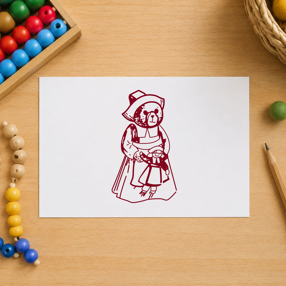 Girl Pilgrim Bear with Doll Rubber Stamp impression in burgundy ink on white paper in a styled craft setting.