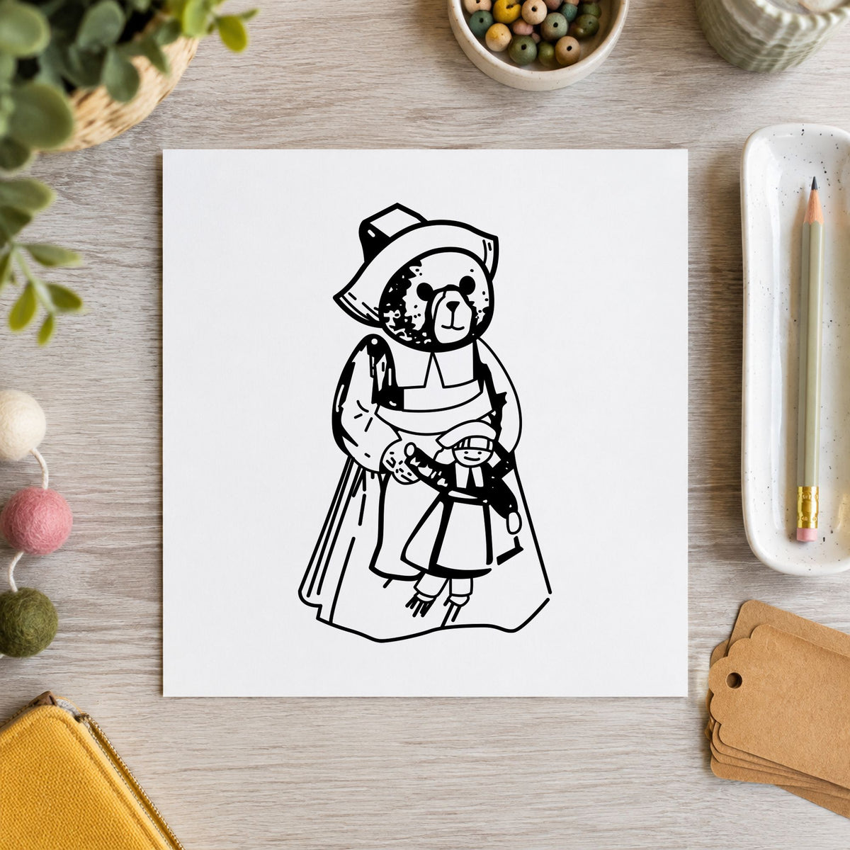Black impression from a pilgrim bear stamp, featuring the girl pilgrim bear with doll design on white paper.