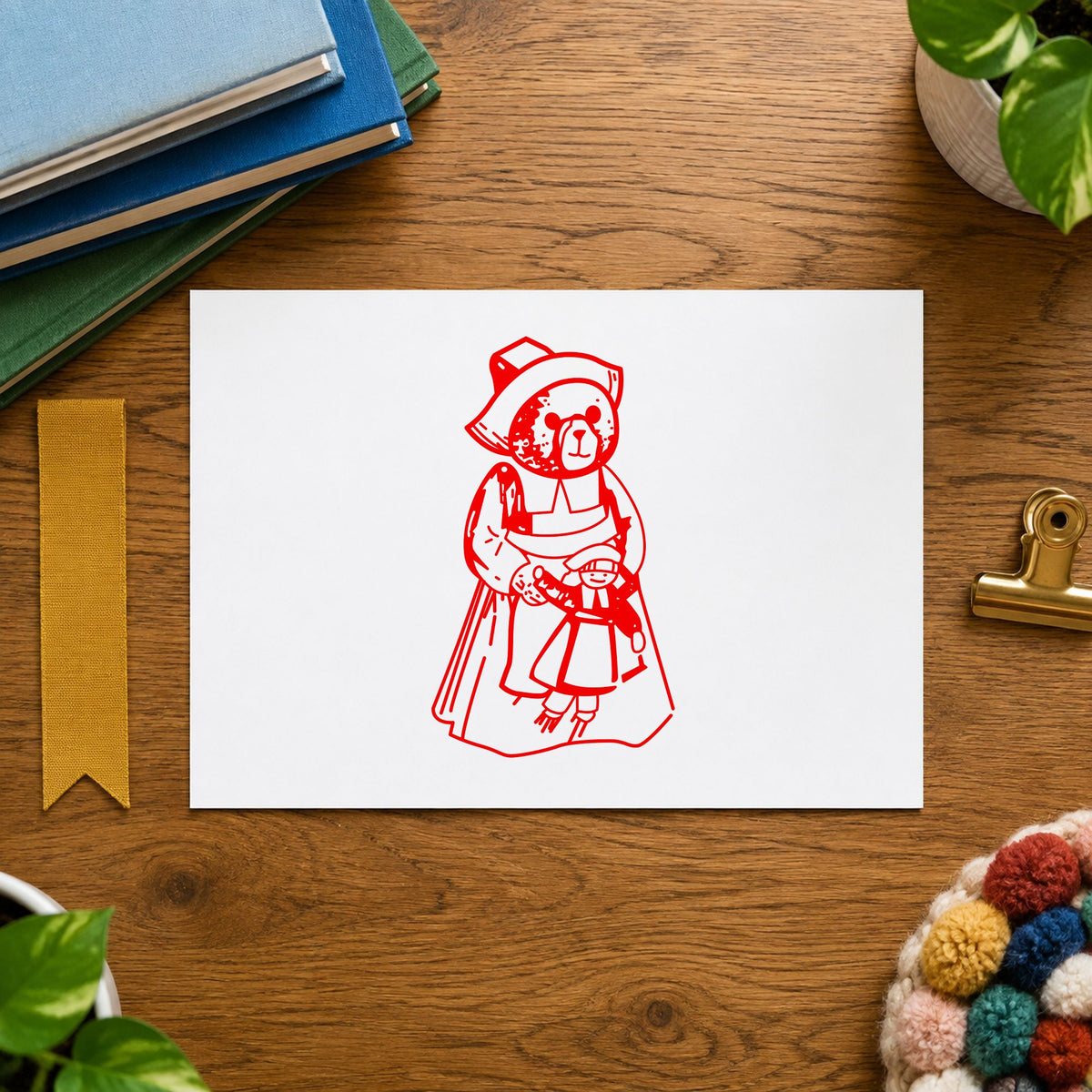 Girl Pilgrim Bear with Doll Rubber Stamp impression in red ink on white paper in a styled craft setting.