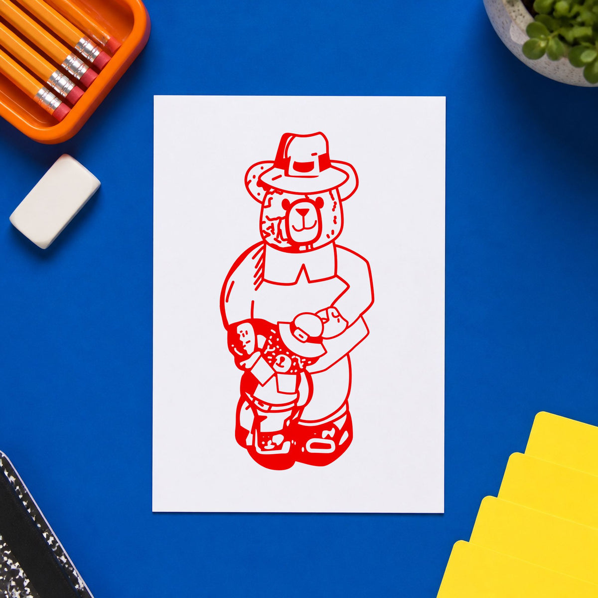 Boy Pilgrim Bear with Teddy Rubber Stamp impression in red ink on white paper in a styled craft setting.