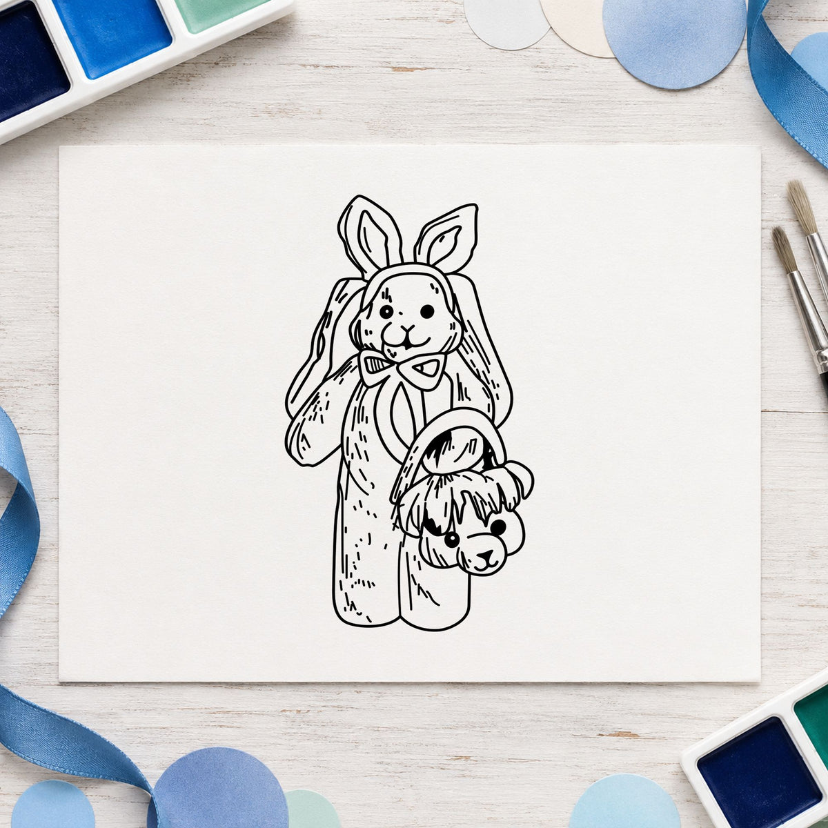 Bunny with Bear Shaped Basket Rubber Stamp impression in black ink on white paper in a styled craft setting.