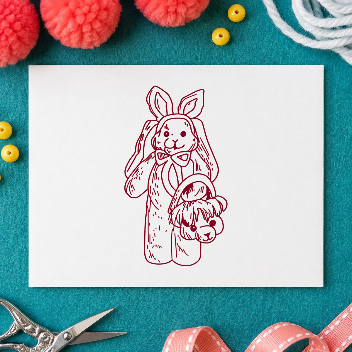 Bunny with Bear Shaped Basket Rubber Stamp impression in burgundy ink on white paper in a styled craft setting.