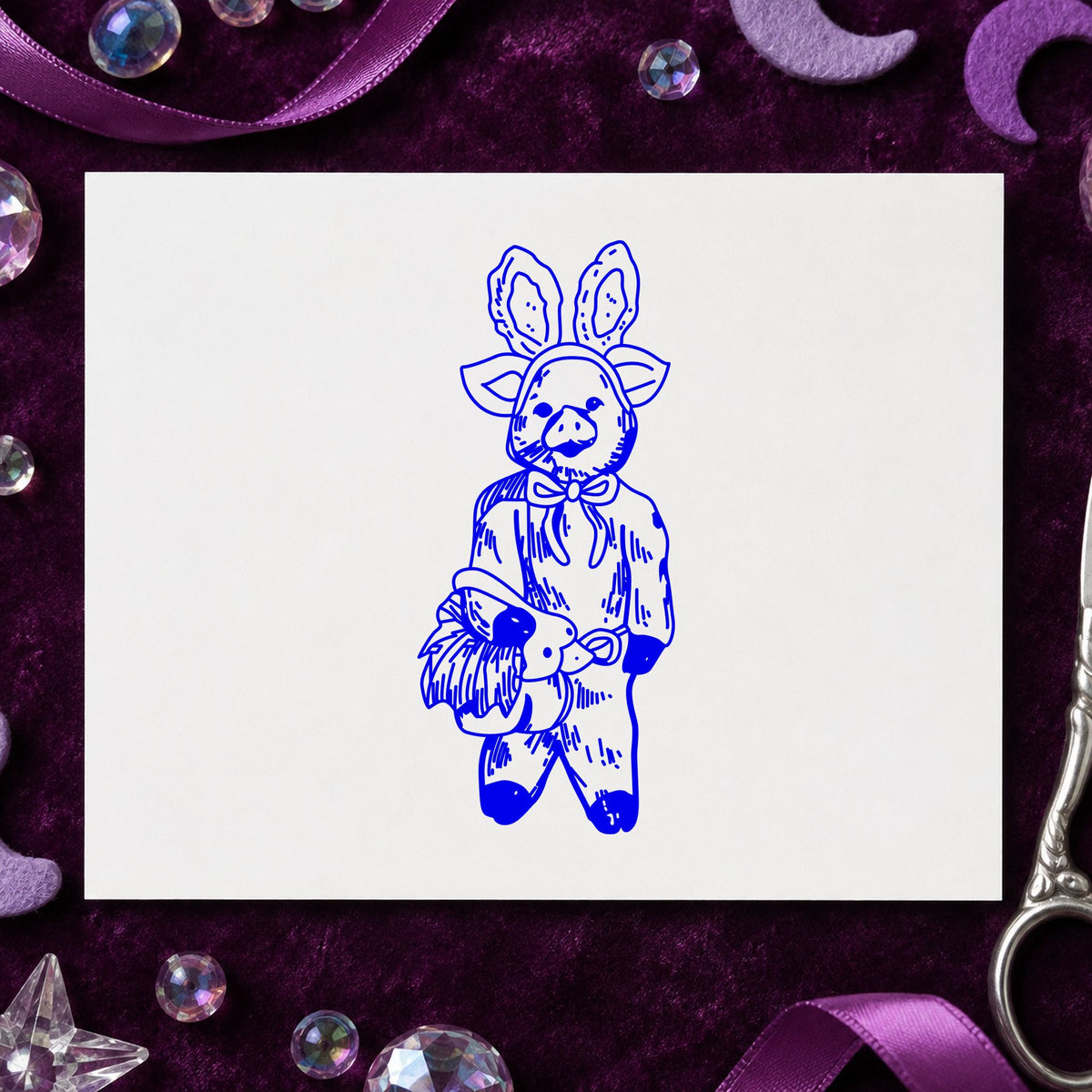 Pig in Bunny Costume with Basket Rubber Stamp impression in blue ink on white paper in a styled craft setting.