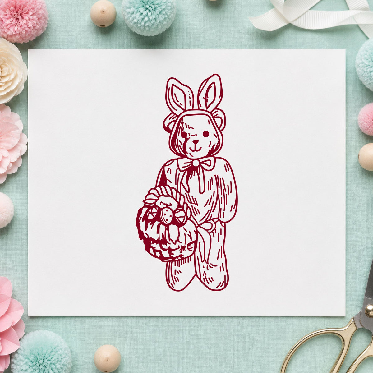 Bear in Bunny Costume with Basket Rubber Stamp impression in burgundy ink on white paper in a styled craft setting.