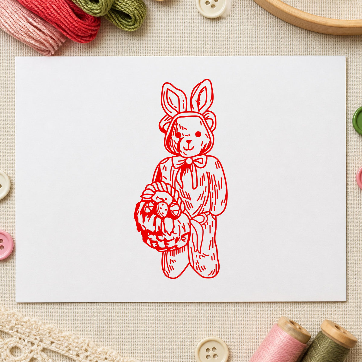 Bear in Bunny Costume with Basket Rubber Stamp impression in red ink on white paper in a styled craft setting.
