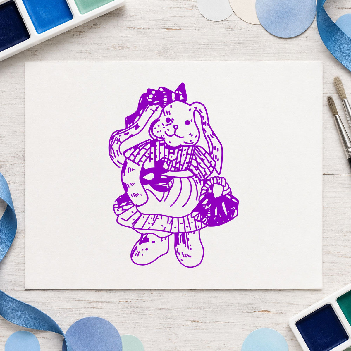 Country Bunny with Basket Rubber Stamp impression in purple ink on white paper in a styled craft setting.