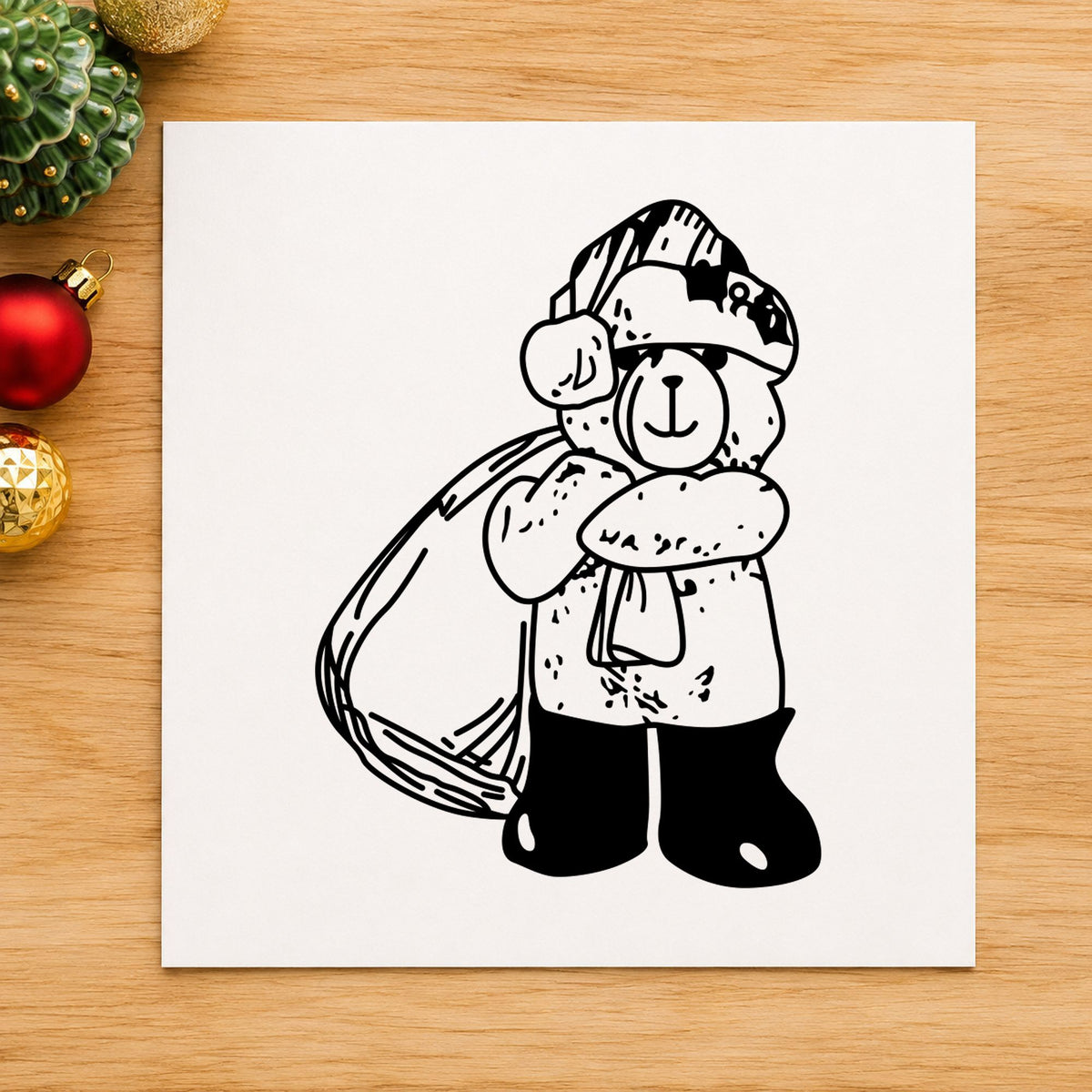 Santa Bear with Gift Bag Rubber Stamp impression in black ink on white paper in a styled craft setting.