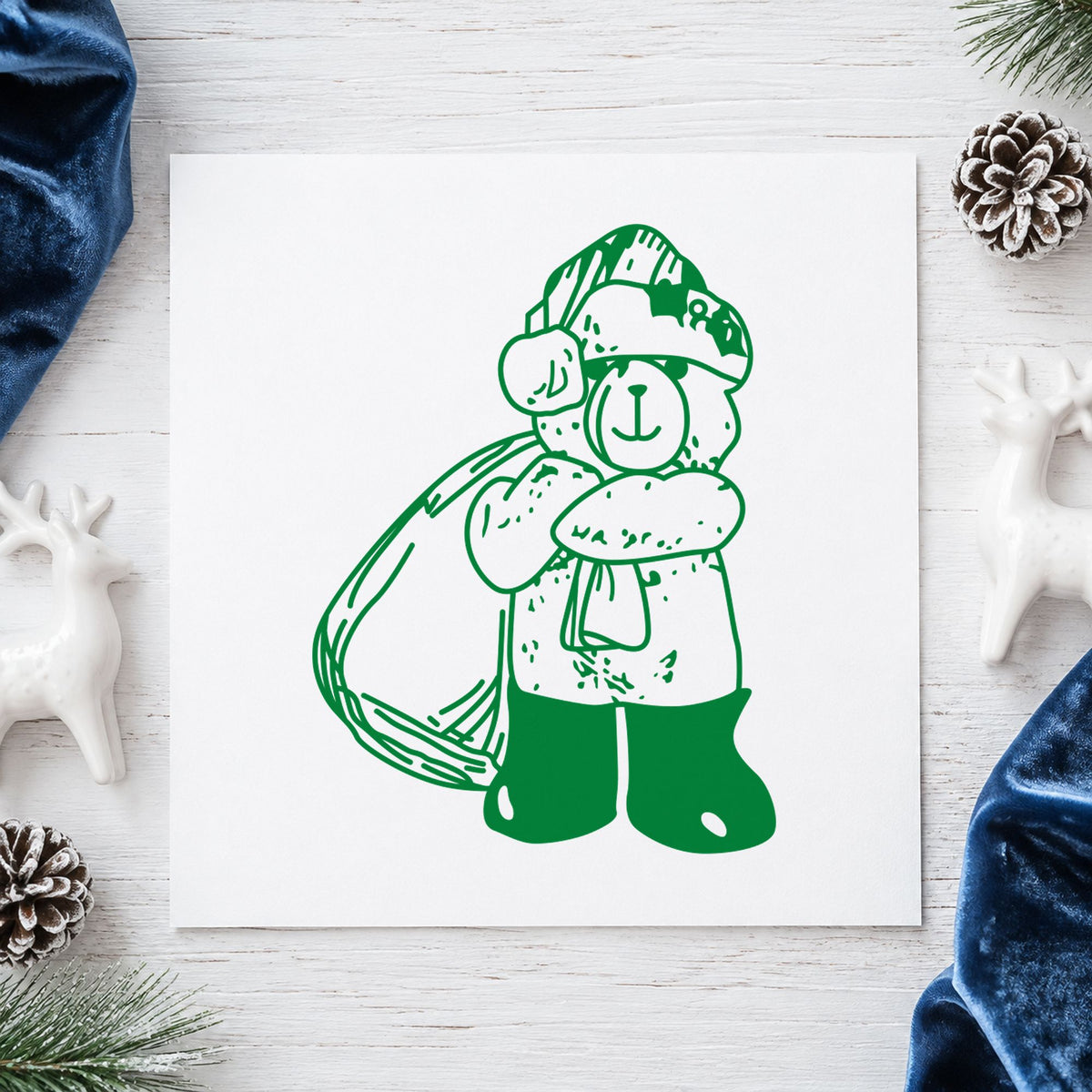 Santa Bear with Gift Bag Rubber Stamp impression in green ink on white paper in a styled craft setting.