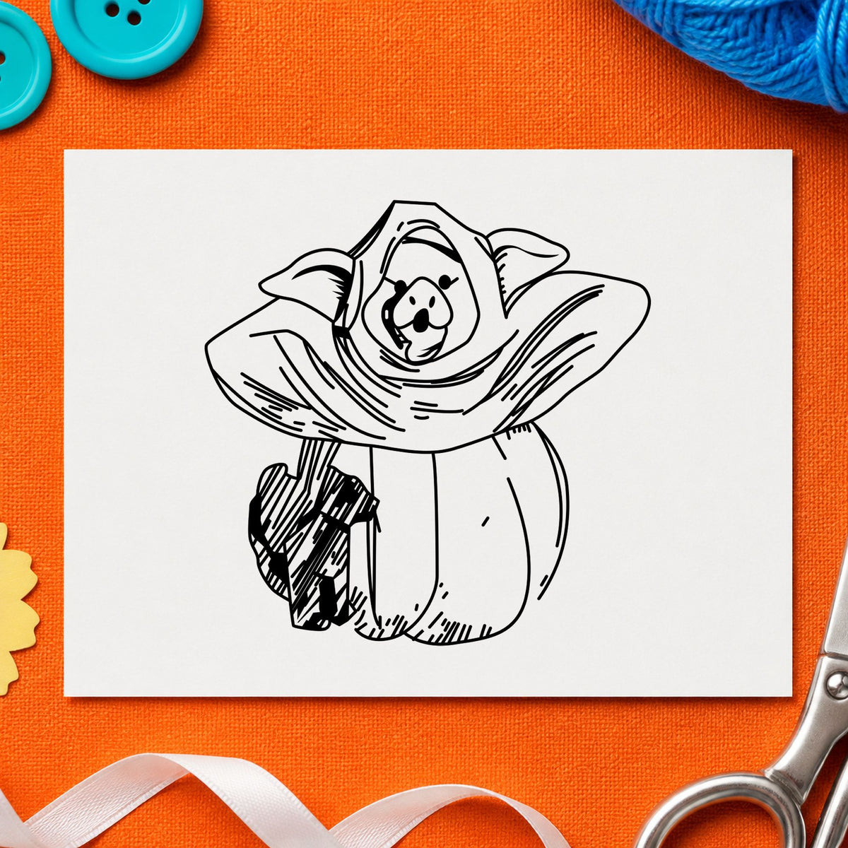 Black impression from a halloween animal stamp, featuring the pumpkin costume pig and black cat design on white paper.