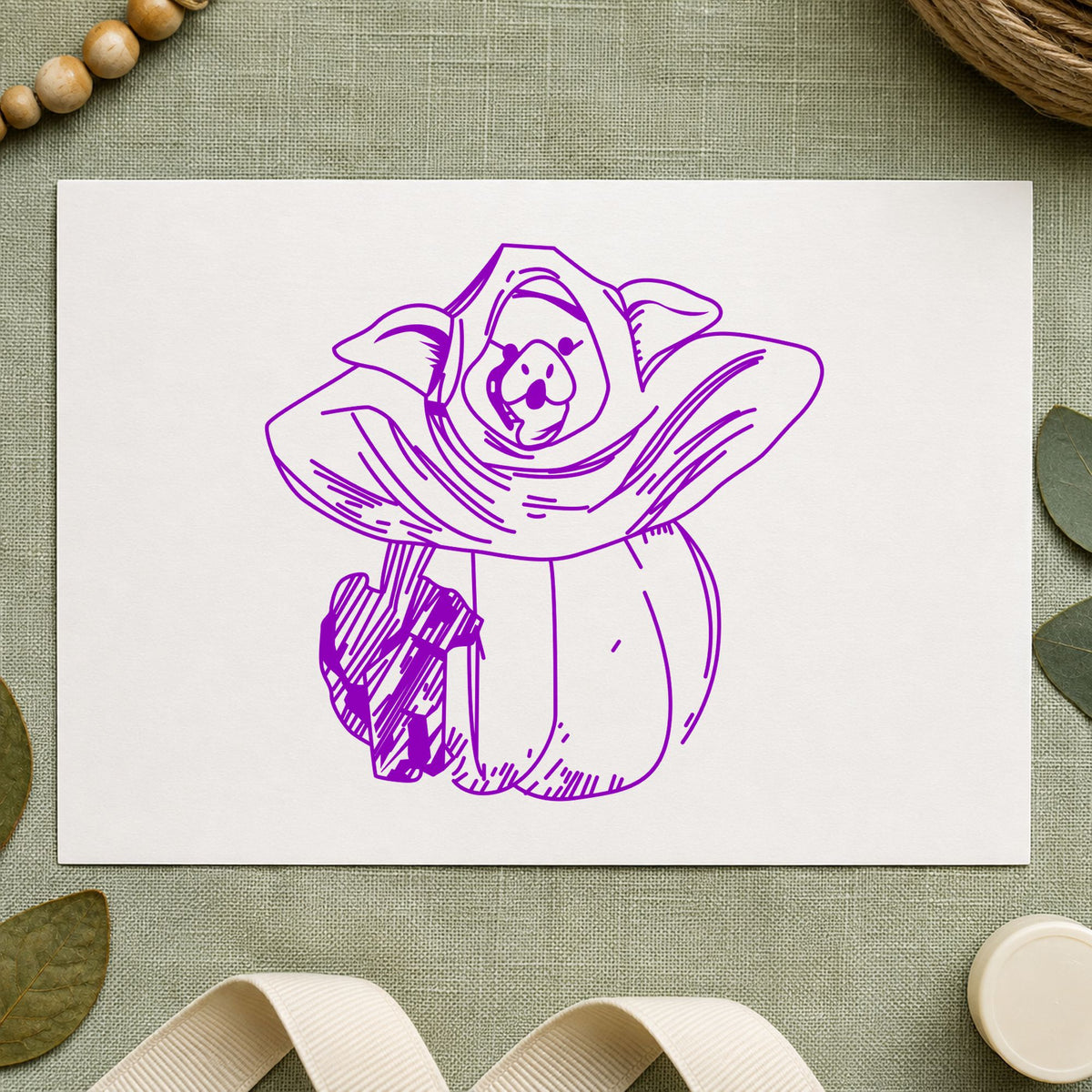 Pumpkin Costume Pig and Black Cat Rubber Stamp impression in purple ink on white paper in a styled craft setting.
