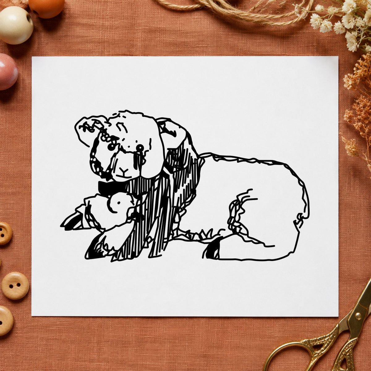 Black impression from a lamb rubber stamp, featuring the lamb and chicken design on white paper.