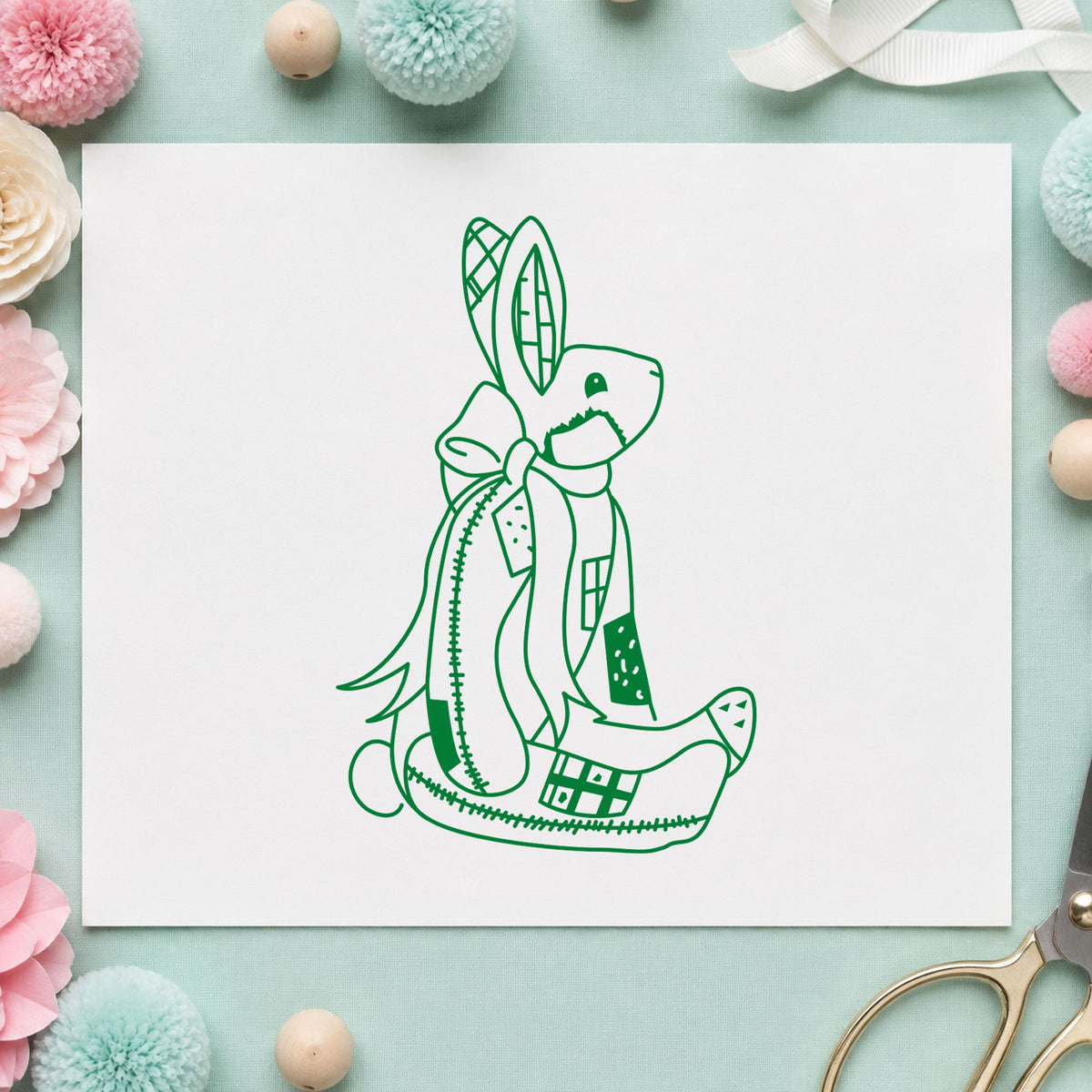 Patchwork Bunny with Bow Rubber Stamp impression in green ink on white paper in a styled craft setting.