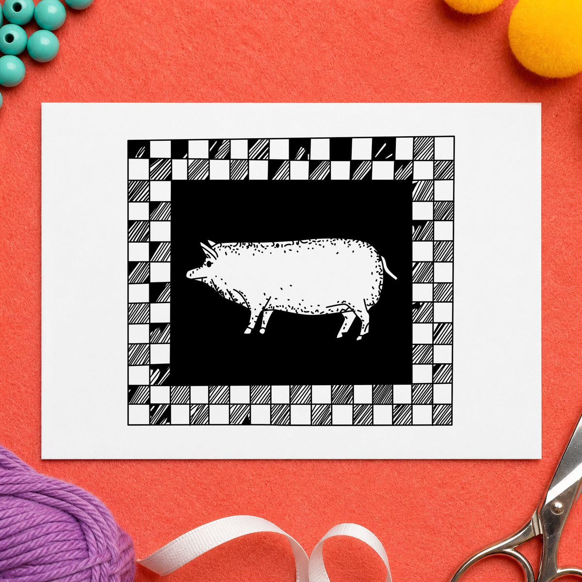 Black impression from a pig rubber stamp, featuring the pig with checkered border design on white paper.
