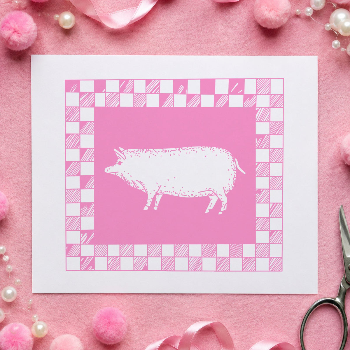 Pig with Checkered Border Rubber Stamp impression in pink ink on white paper in a styled craft setting.