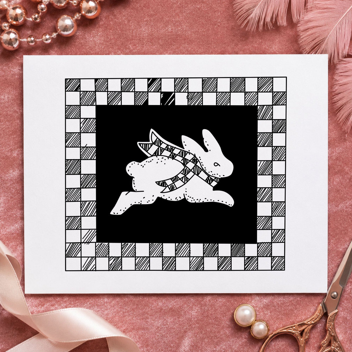 Black impression from a bunny rubber stamp, featuring the rabbit with checkered border design on white paper.