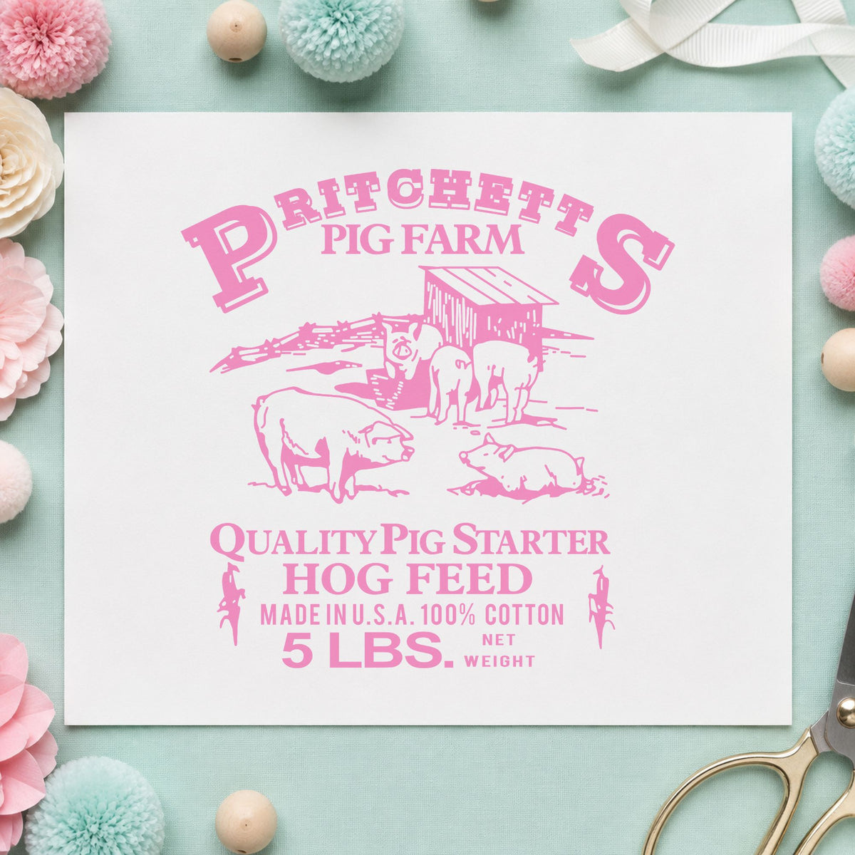 Hog Feed Label Rubber Stamp impression in pink ink on white paper in a styled craft setting.