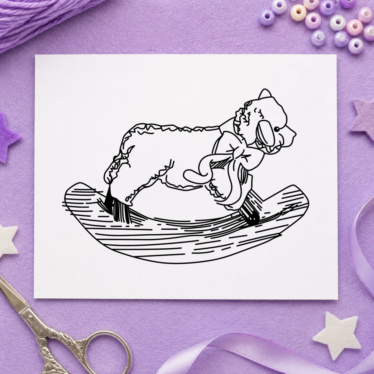 Black impression from a sheep rubber stamp, featuring the rocking sheep design on white paper.