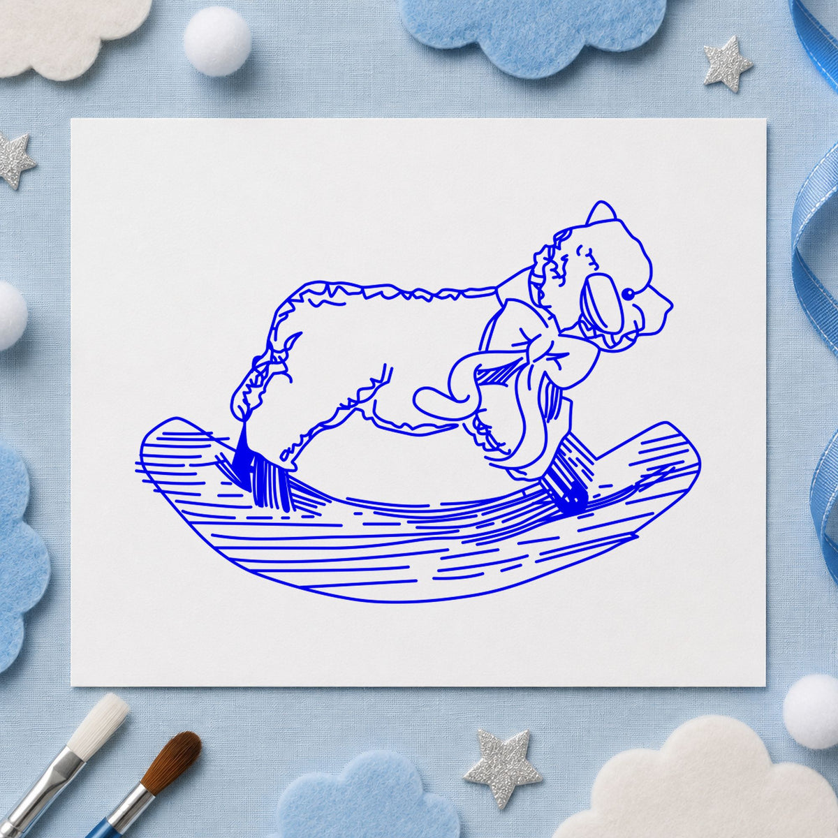 Rocking Sheep Rubber Stamp impression in blue ink on white paper in a styled craft setting.