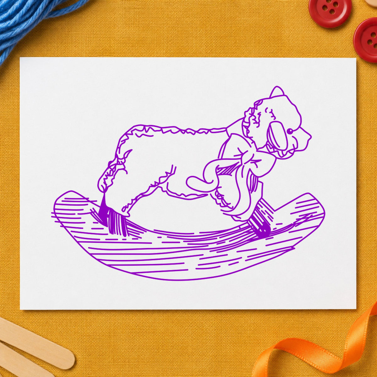 Rocking Sheep Rubber Stamp impression in purple ink on white paper in a styled craft setting.