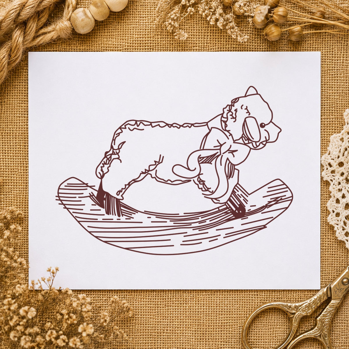 Rocking Sheep Rubber Stamp impression in brown ink on white paper in a styled craft setting.