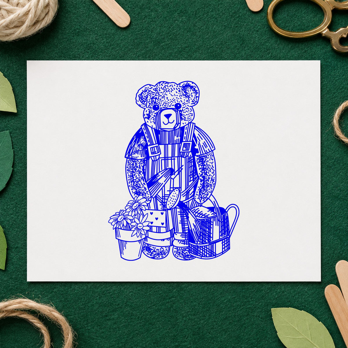 Teddy Bear Riding Rocking Horse Rubber Stamp impression in blue ink on white paper in a styled craft setting.