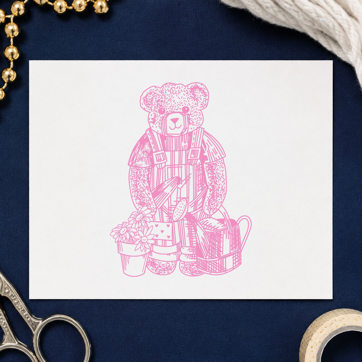 Teddy Bear Riding Rocking Horse Rubber Stamp impression in pink ink on white paper in a styled craft setting.