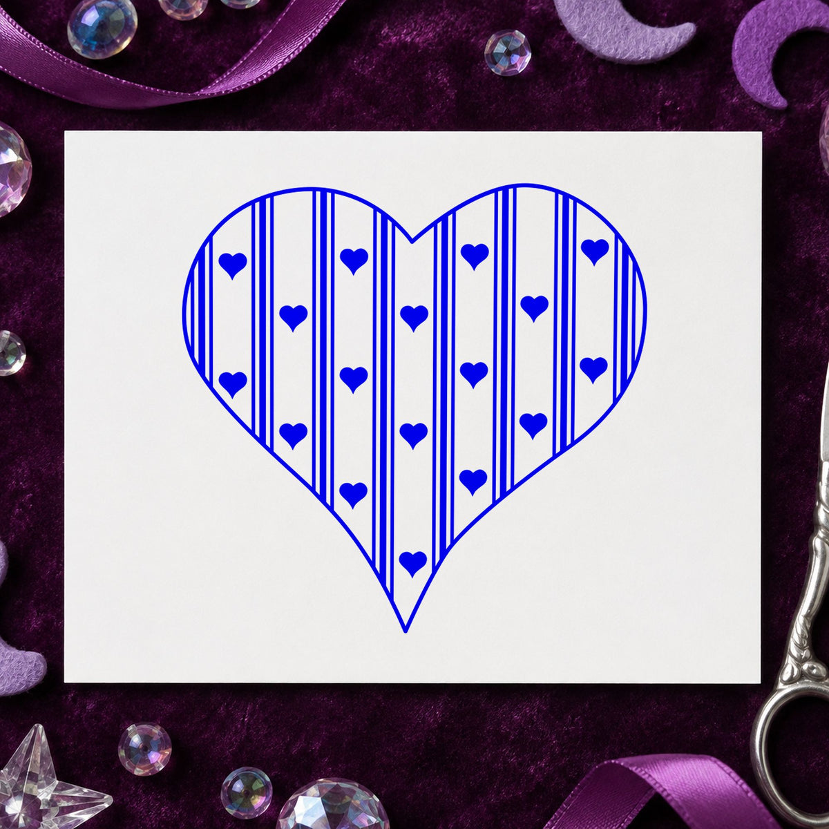 Blue country craft stamp impression featuring the striped country heart design on white paper.
