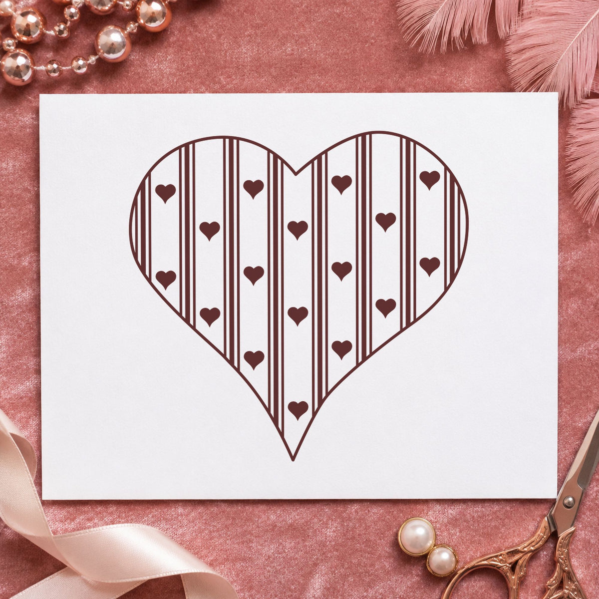 Striped Country Heart Rubber Stamp impression in brown ink on white paper in a styled craft setting.