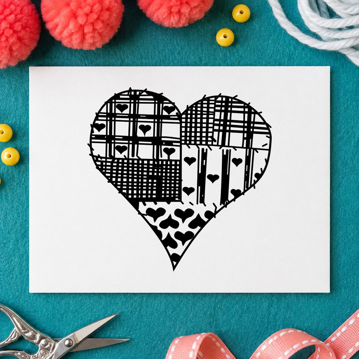 Black impression from a heart rubber stamp, featuring the patchwork country heart design on white paper.