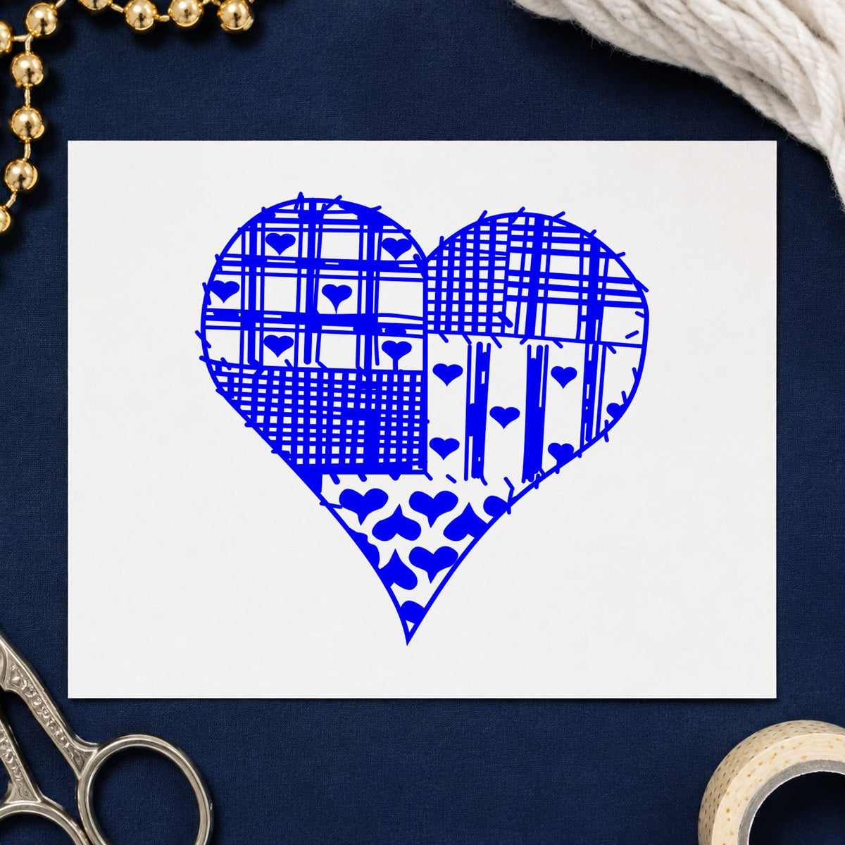Patchwork Country Heart Rubber Stamp impression in blue ink on white paper in a styled craft setting.