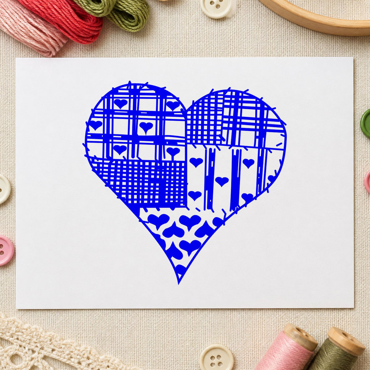 Blue patchwork craft stamp impression featuring the patchwork country heart design on white paper.