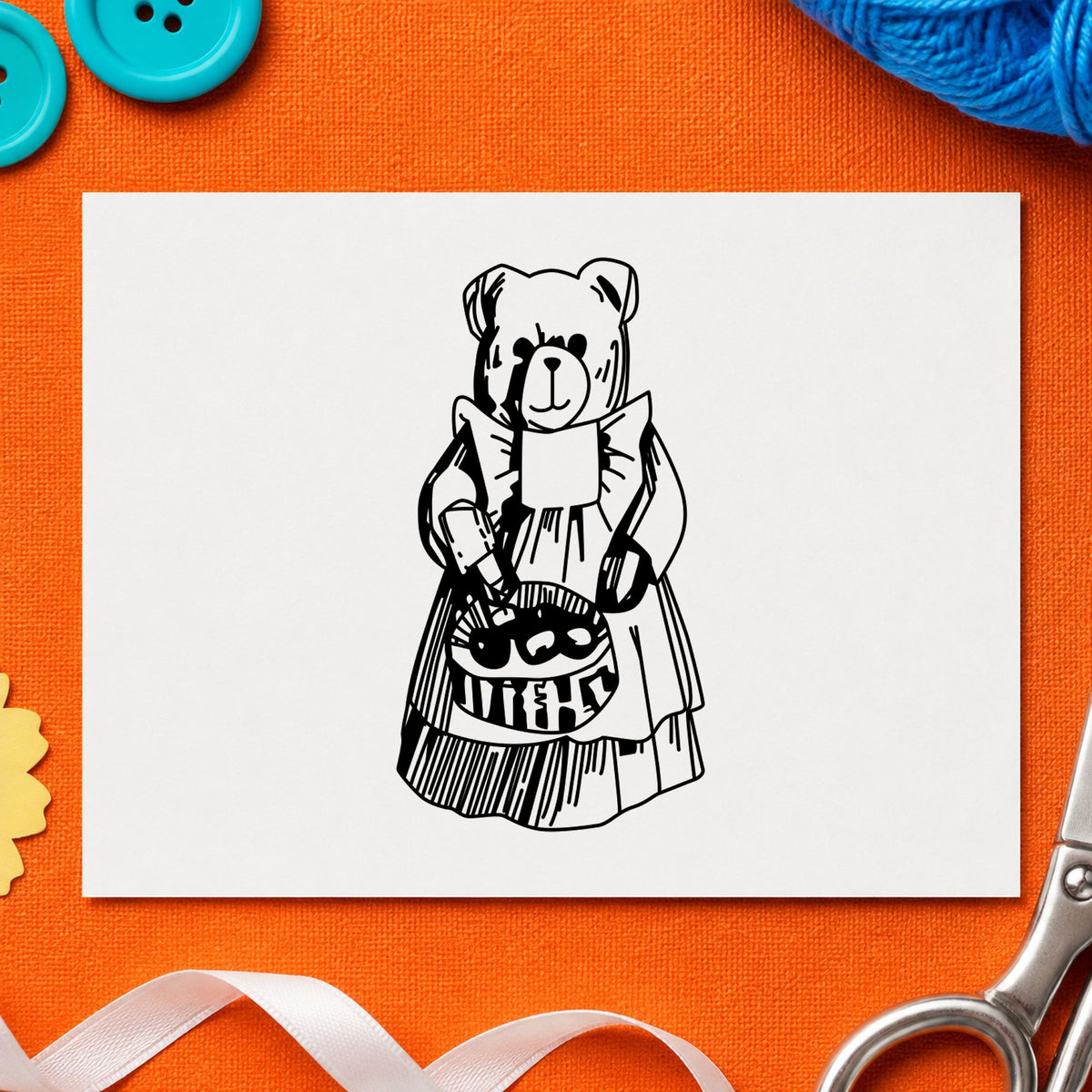 Black impression from a teddy bear rubber stamp, featuring the country bear with produce basket design on white paper.