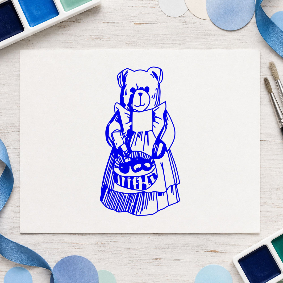 Country Bear with Produce Basket Rubber Stamp impression in blue ink on white paper in a styled craft setting.