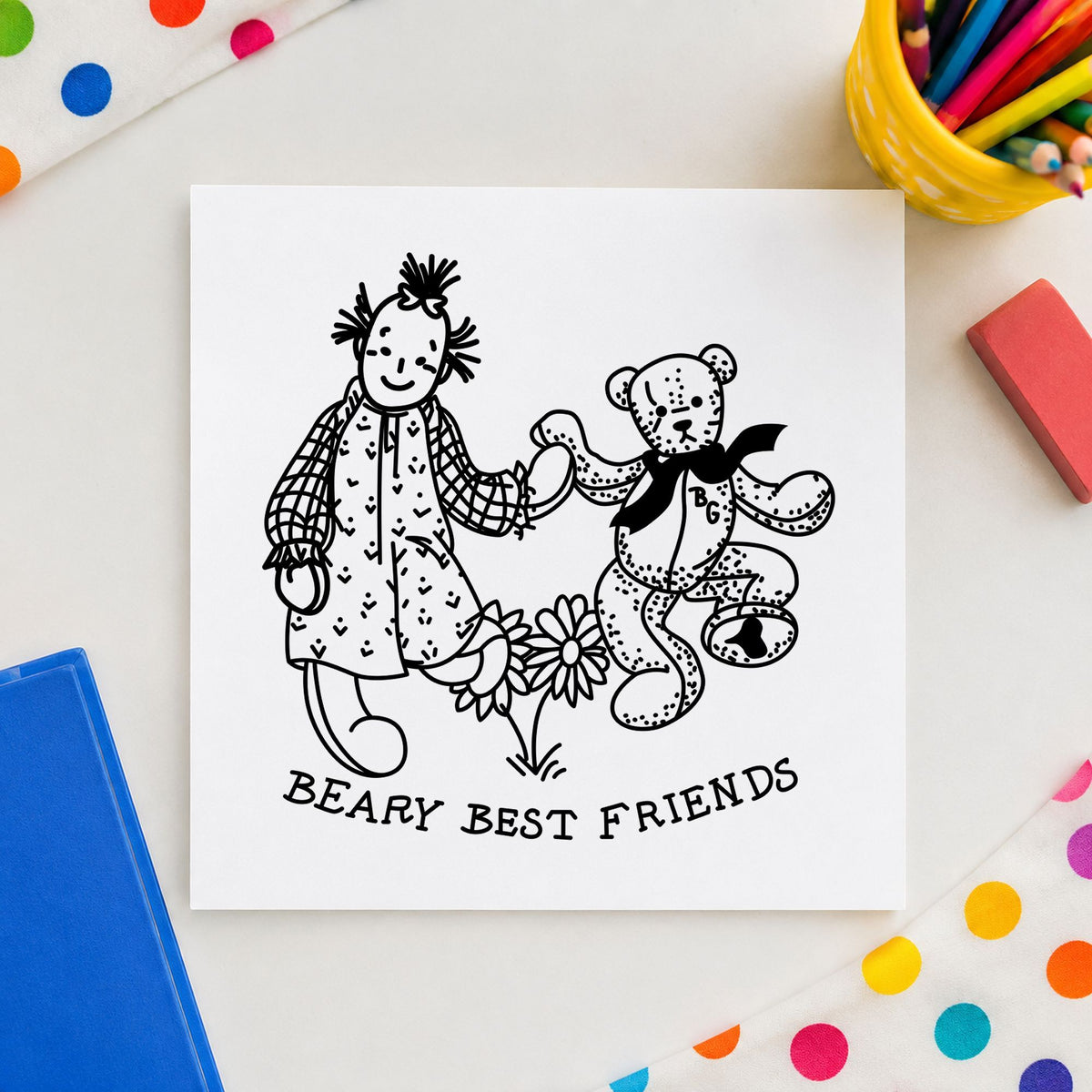 Beary Best Friends Bear and Doll Rubber Stamp impression in black ink on white paper in a styled craft setting.